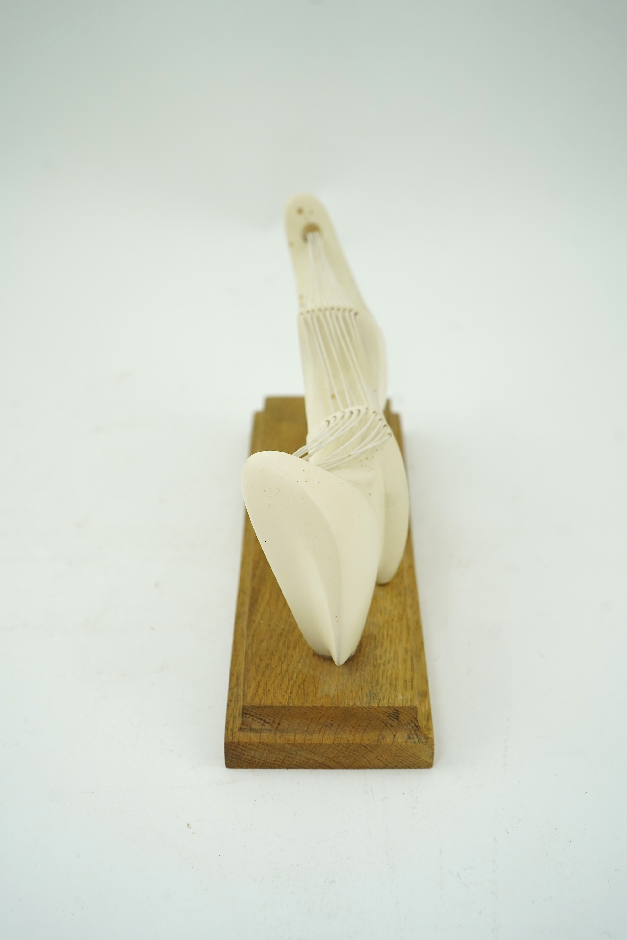 Follower of Henry Moore (1898-1986) A modernist stringed plaster sculpture raised on an oak rectangular plinth base, 25cm wide